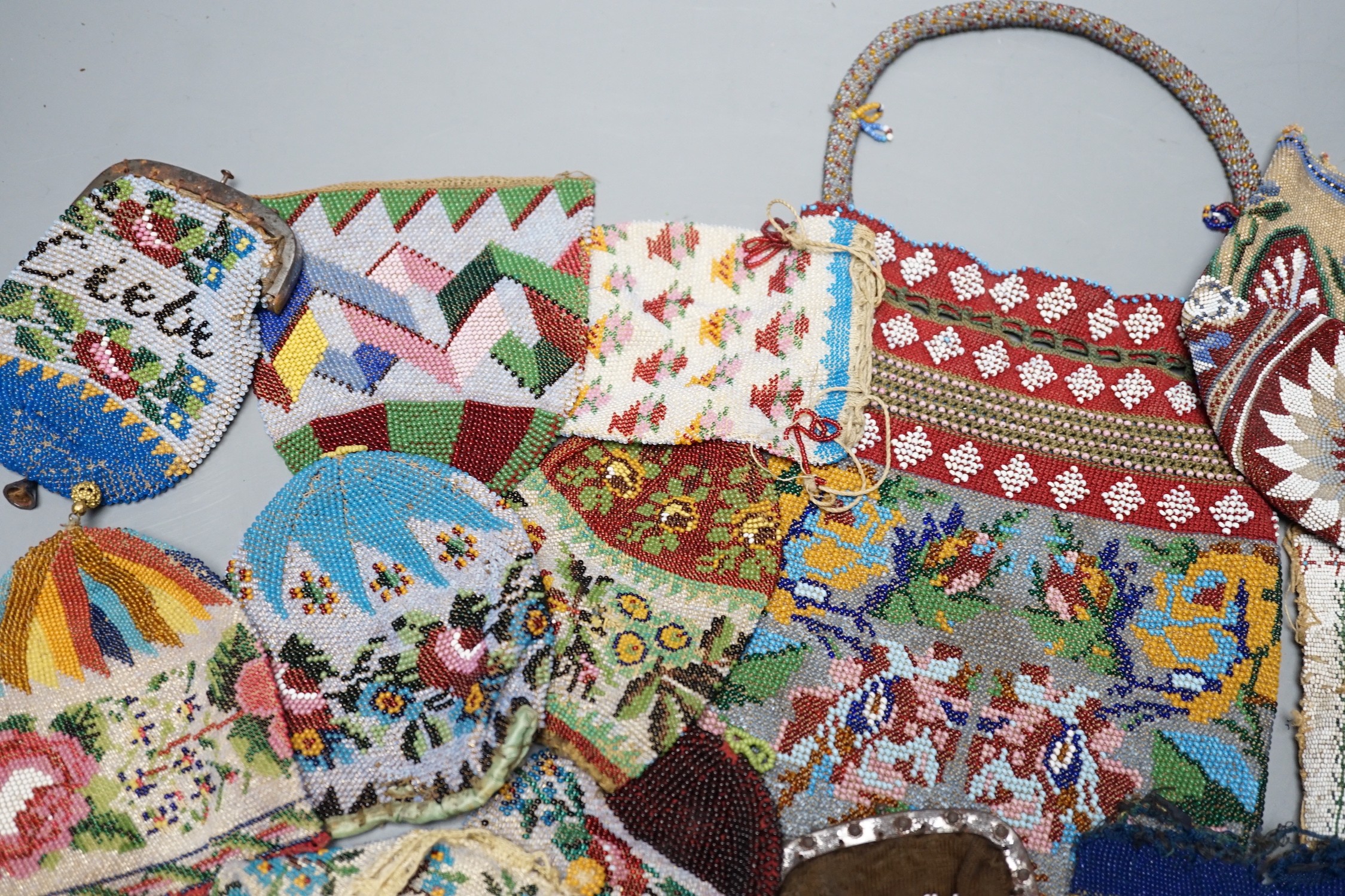 Three Victorian beadwork bags, circa 1860, largest 17cm high, and a collection of eleven smaller reticules and purses